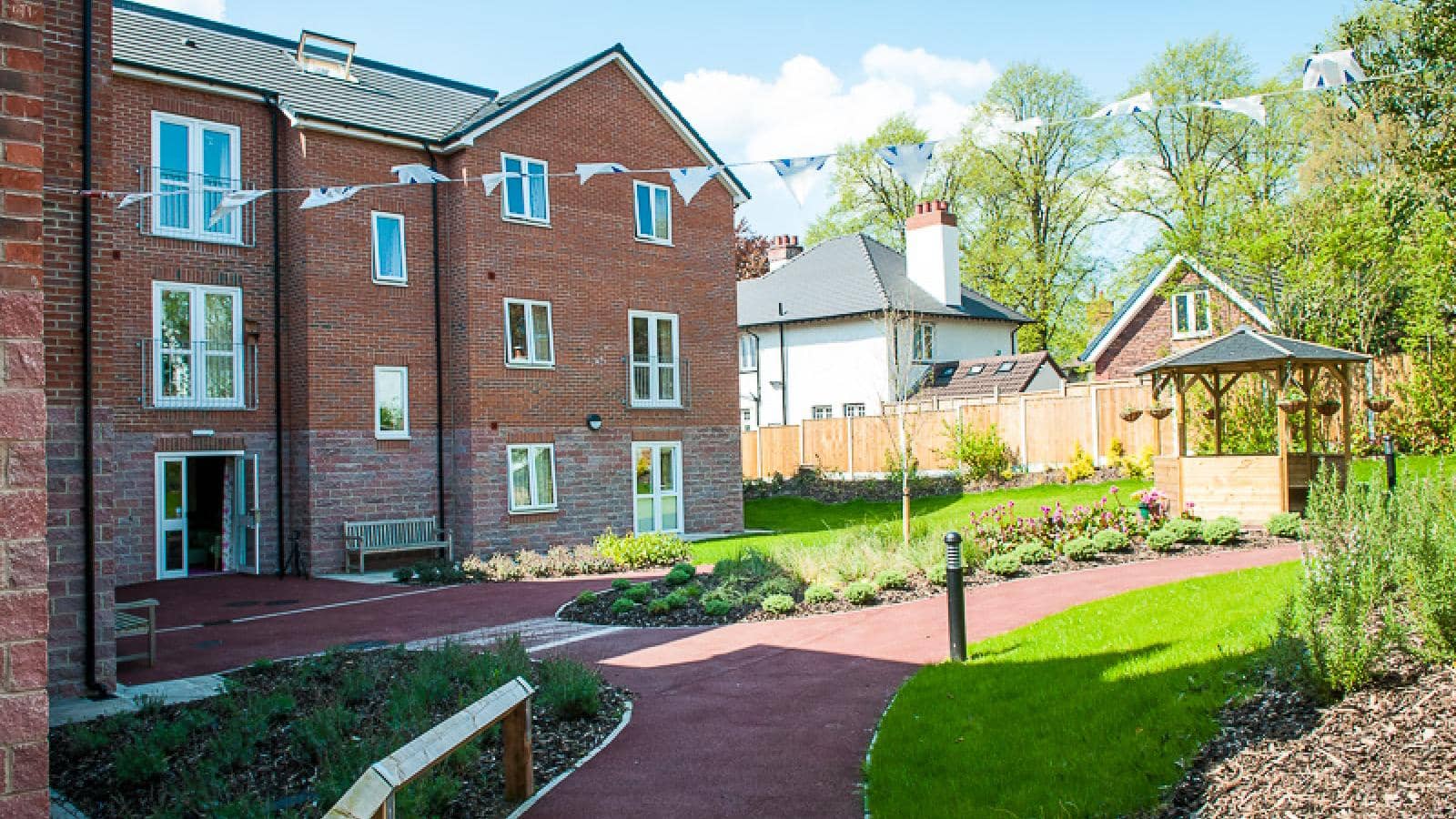 MHA Fulwood Court retirement living gardens and pathways in the sunshine