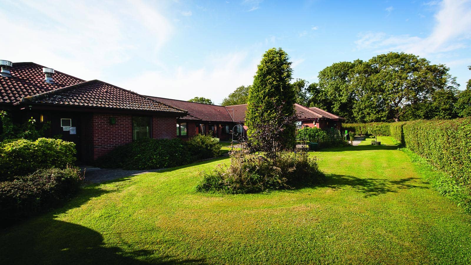 MHA Warde Aldam gardens lawns and trees on a sunny day