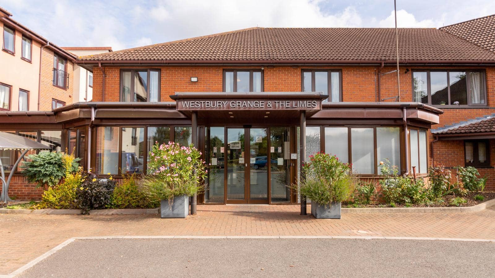 Reception of Westbury Grange care home in Newport Pagnel with bushes and shrubbery