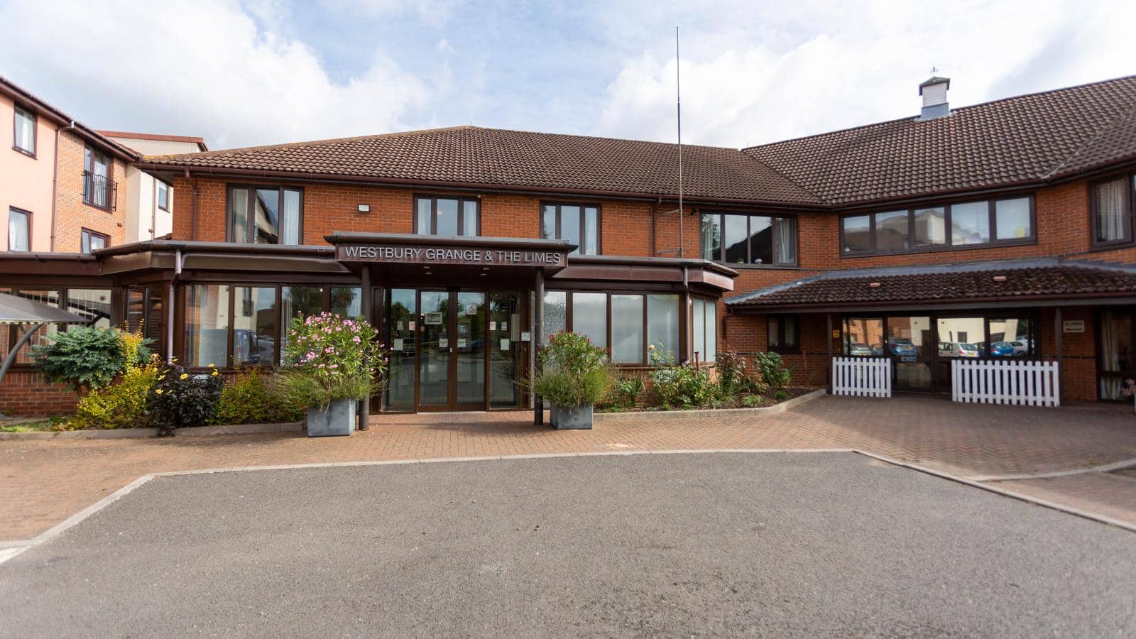 Exterior of Westbury Grange care home from the care park on a sunny day