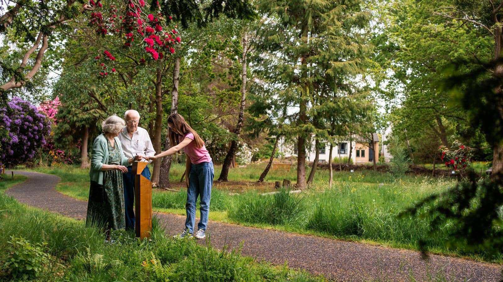 A family walking through the Wilderness, an extensive MHA garden area situated directly behind Hall Grange.