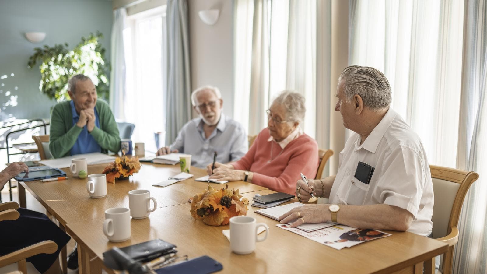 A group of retirement living residents are having a meeting 