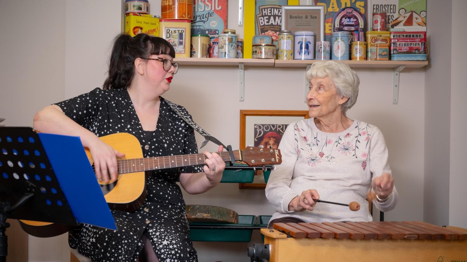 Music therapist sings with a resident