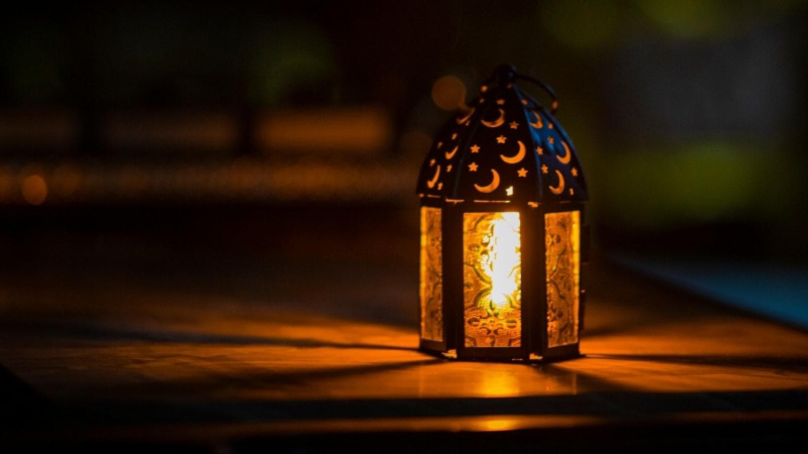 A lantern burns brightly in the dark.