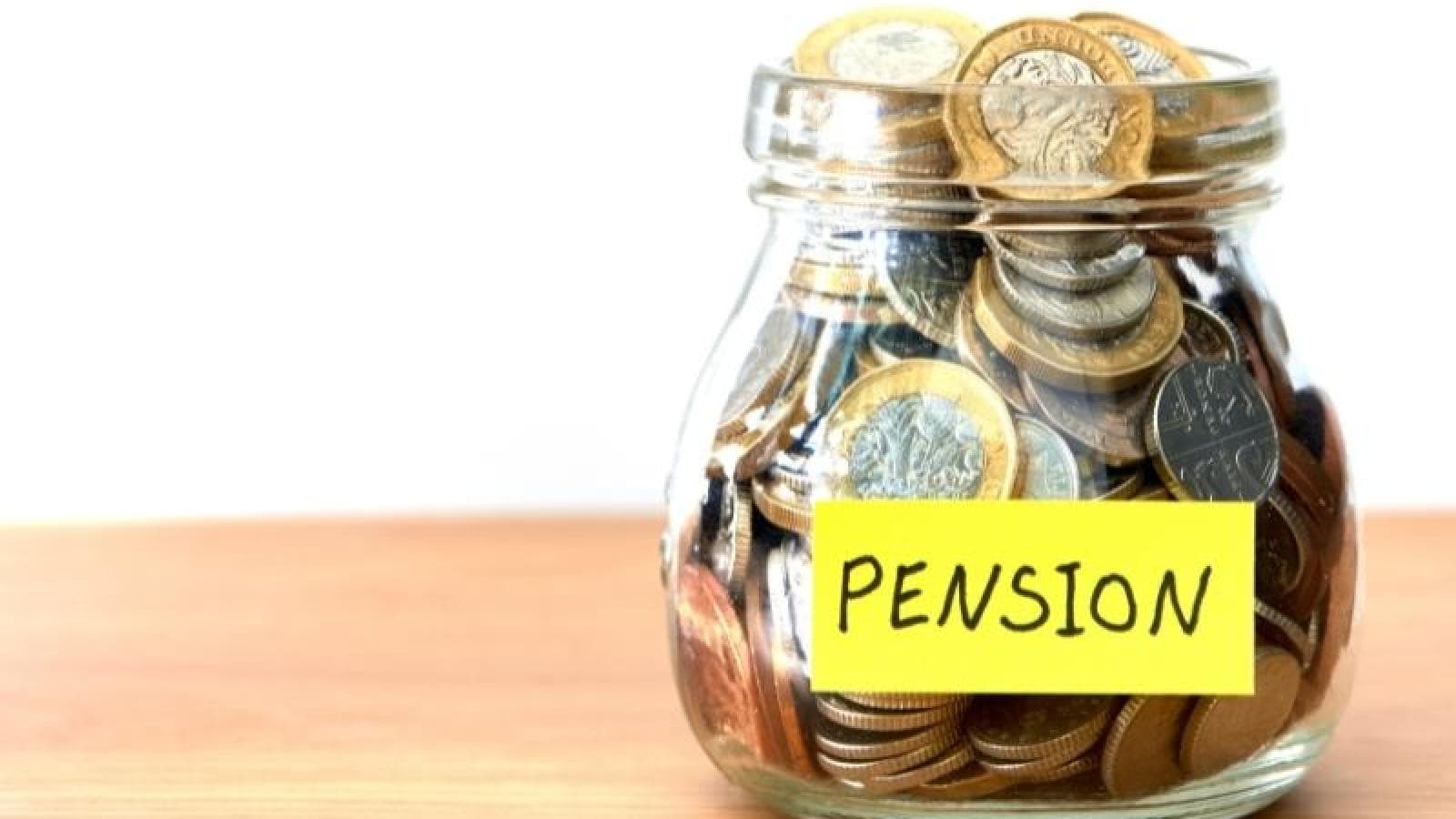 A jar is full of change and labelled pension 