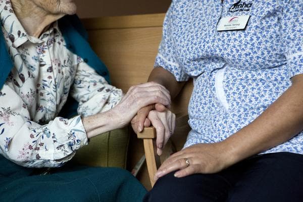 Riverview Lodge - resident & Care Assistant holding hands
