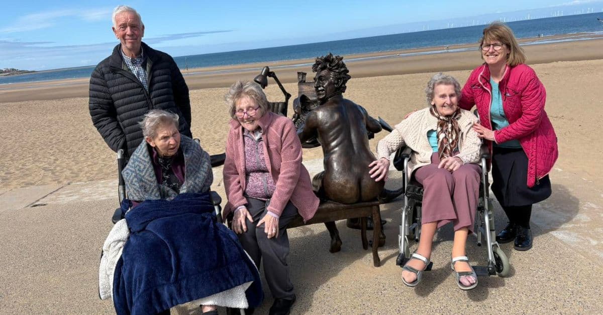 Residents and staff at MHA Coed Craig make short journey to beach to see Terry Jones statue